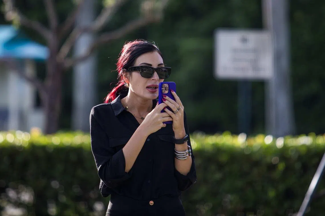 FILE Ñ The far-right activist and conspiracy theorist Laura Loomer on her phone, on the afternoon of a shooting on the grounds of the Trump International Golf Course in West Palm Beach, Fla. on Sept. 15, 2024. Loomer reportedly met with President Donald Trump in the Oval Office on April 2, 2025, where she pressed for him to fire National Security Council staff members whom she deemed disloyal to him. (Saul Martinez/The New York Times) 