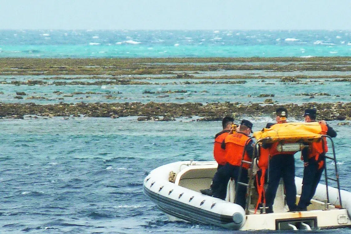 In this photo taken on December 25, 2022, Chinese coast personnel aboard an inflatable boat patrol Scarborough Shoal in the South China Sea. (Photo by AFP)