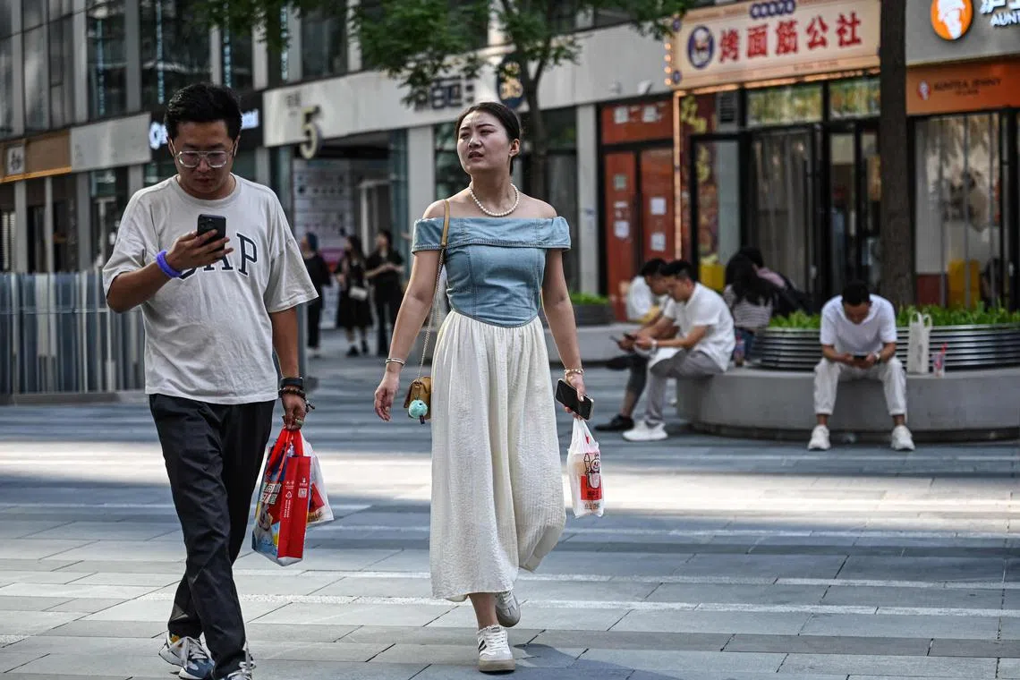 Consumers in China are delaying purchases while businesses slash wages.