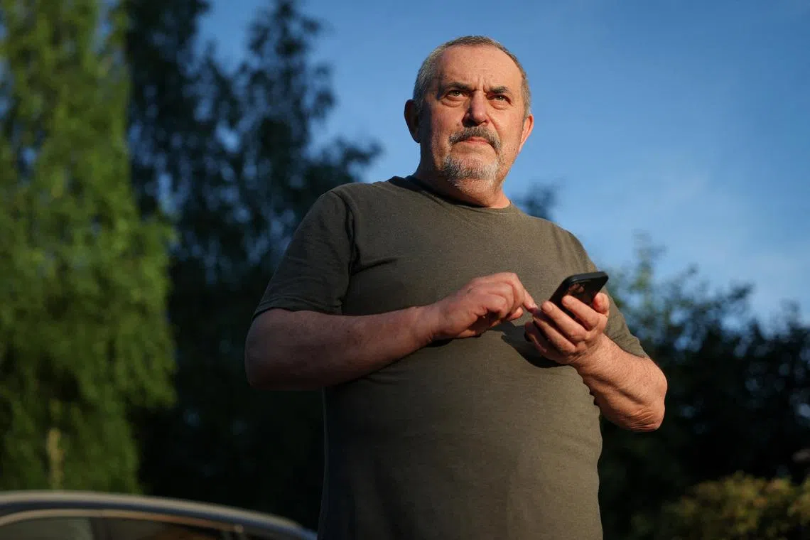 Boris Nadezhdin, an anti-war Russian politician, checks his phone after he has been released from police station in Dolgoprudny, Moscow region, Russia July 13, 2026.  REUTERS/Ramil Sitdikov