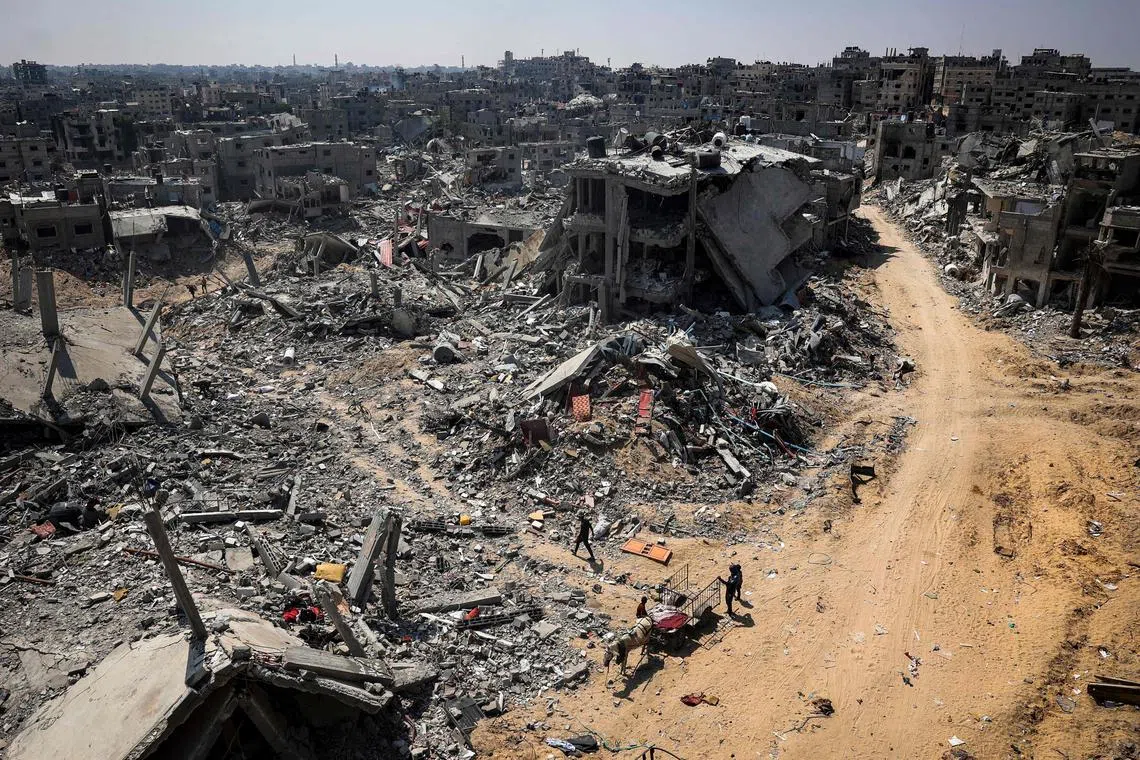 People looking for salvageable items amid the rubble of buildings destroyed during Israeli bombardment in Khan Yunis, on the southern Gaza Strip, on April 16, 2024, as fighting continues between Israel and Hamas. 
