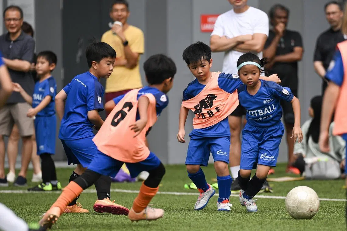 Nur Huraiyah Shakira Salehin (first from right) 8, taking part in an Under-8 mixed team match during the ActiveSG Football Academy (AFA) Football Fiesta at Our Tampines Hub on May 24.