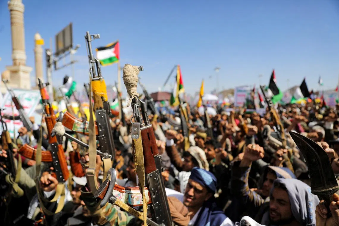 FILE PHOTO: Protesters hold up rifles during a rally organized by the Houthis in support of Palestinians in the Gaza Strip, amid the ongoing conflict between Israel and the Palestinian Islamist group Hamas, in Sanaa, Yemen March 22, 2024. REUTERS/Khaled Abdullah/File Photo