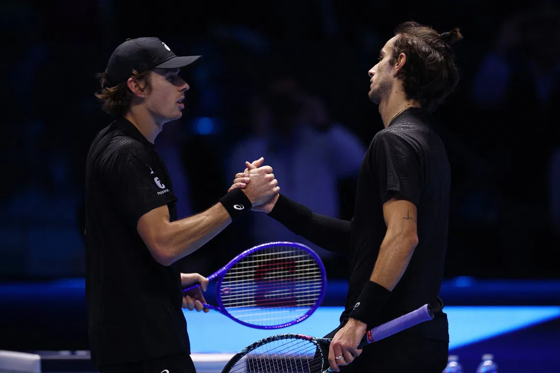 Tennis - ATP Finals - Turin - Palasport Olimpico, Turin, Italy - November 11, 2025 Italy's Lorenzo Musetti shakes hands with Australia's Alex De Minaur after winning his group stage match REUTERS/Guglielmo Mangiapane