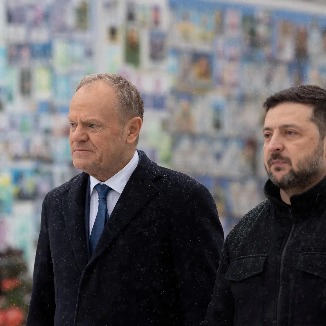 FILE PHOTO: Ukraine's President Volodymyr Zelenskiy and Polish Prime Minister Donald Tusk visit the Wall of Remembrance of the Fallen for Ukraine outside the Saint Michael's Cathedral, amid Russia's attack on Ukraine, in Kyiv, Ukraine February 5, 2026. Ukrainian Presidential Press Service/Handout via REUTERS /File Photo