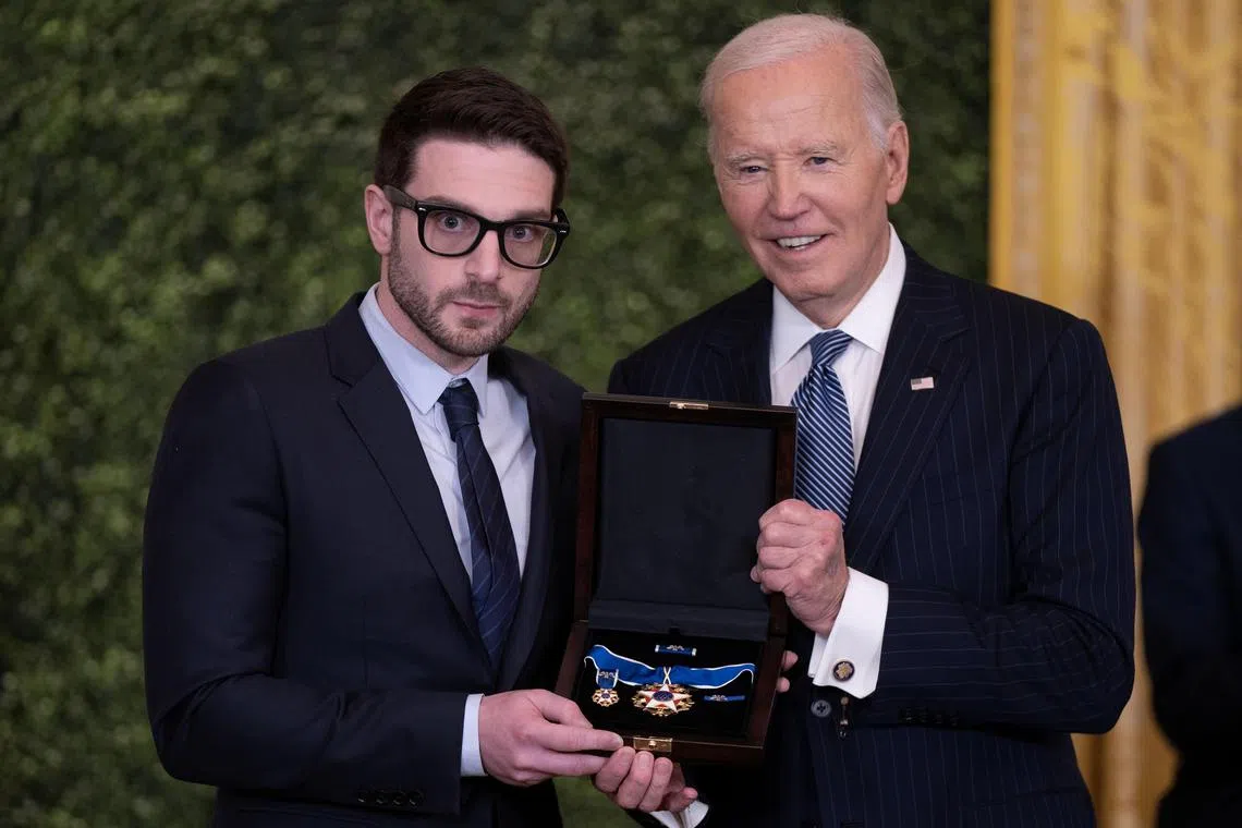 US President Joe Biden (right) presents Alex Soros, son of award recipient George Soros with the Presidential Medal of Freedom.