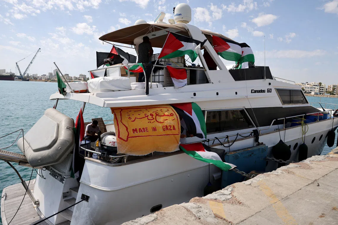 FILE PHOTO: People gather on a boat from a flotilla that had been carrying aid to Gaza until it was intercepted by Israel, docked in the port of Larnaca, Cyprus October 3, 2025. REUTERS/Yiannis Kourtoglou/File Photo