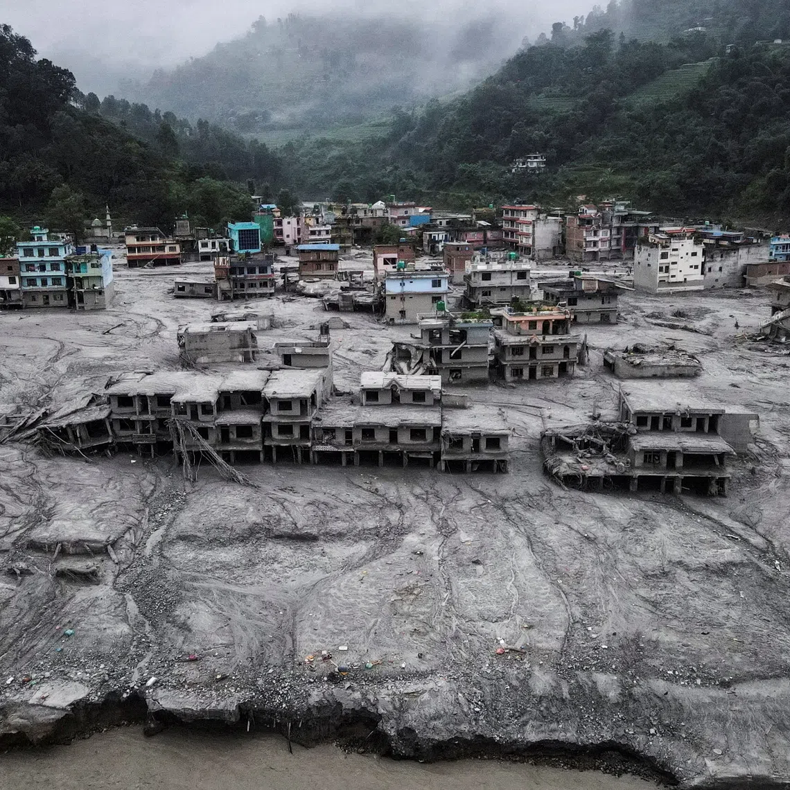 A drone view shows houses covered in mud after the flash floods and mudslide, at Devighat, Nuwakot district, Nepal, August 29, 2026.