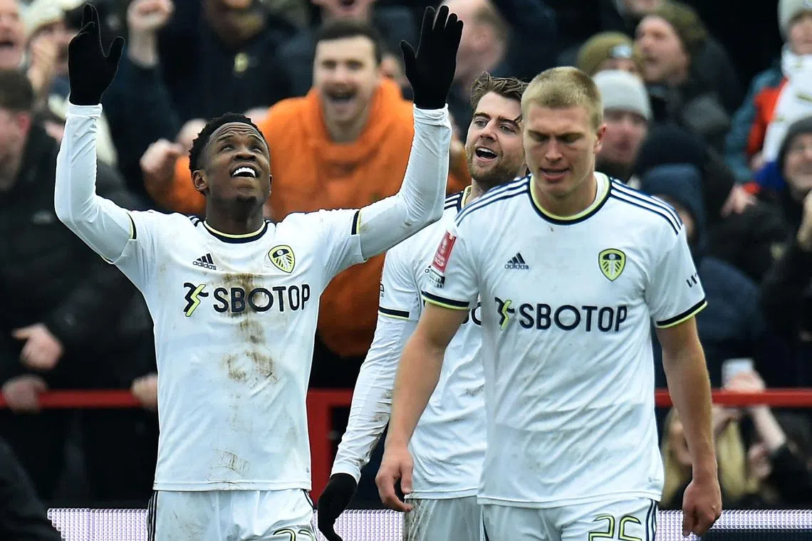 Leeds United's Colombian striker Luis Sinisterra (L) celebrates scoring the team's third goal during the English FA Cup fourth round football match between Accrington Stanley and Leeds United at the Wham Stadium in Accrington, north west England on January 28, 2023. (Photo by PETER POWELL / AFP) / RESTRICTED TO EDITORIAL USE. No use with unauthorized audio, video, data, fixture lists, club/league logos or 'live' services. Online in-match use limited to 120 images. An additional 40 images may be used in extra time. No video emulation. Social media in-match use limited to 120 images. An additional 40 images may be used in extra time. No use in betting publications, games or single club/league/player publications. / 