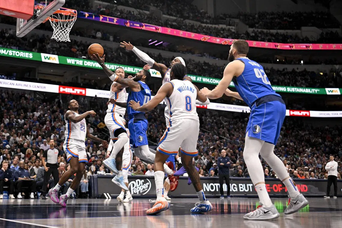 Dallas Mavericks guard Kyrie Irving drives to the basket against the Oklahoma City Thunder during the second half at the American Airlines Centre.
