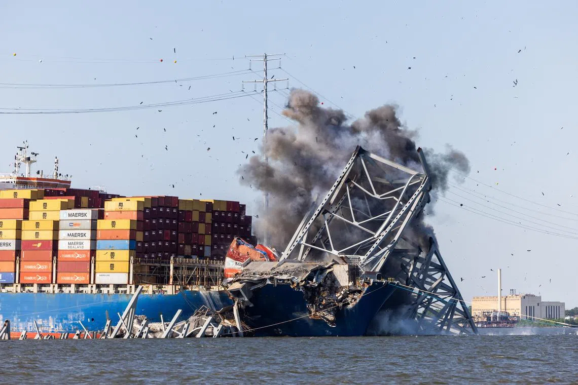 Engineers detonate controlled explosives to remove a steel span from the Key Bridge from the bow of the Dali container ship in Baltimore, Maryland, on May 13. Following the detonation, the 600-ton truss sank into the Patapsco River.  EPA-EFE