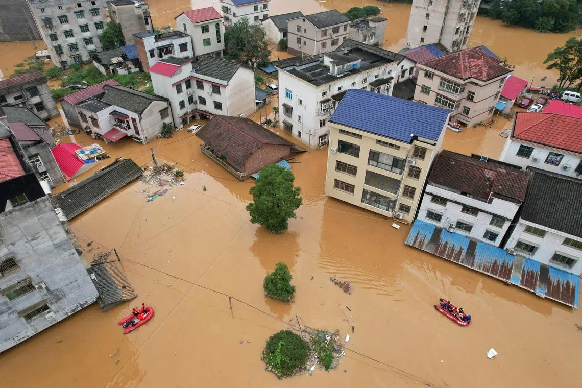 A drone view shows flooded buildings following heavy rainfall in Pingjiang county of Yueyang, Hunan province, China July 2, 2024. cnsphoto via REUTERS/File Photo