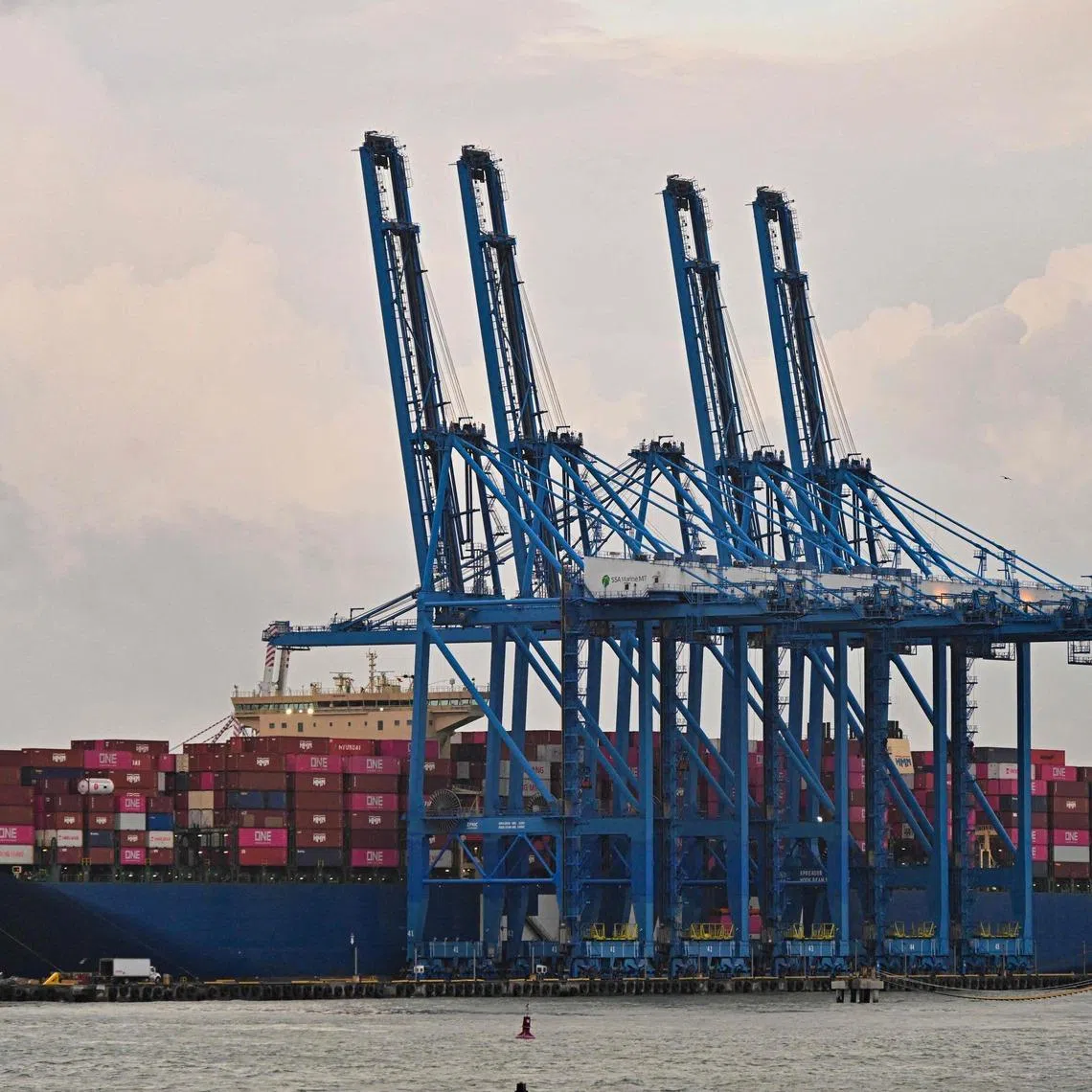 The South Korean cargo ship HMM VICTORY is pictured docked at the Colon port in Colon province, Panama, on February 6, 2026. The subsidiary of Hong Kong-based CK Hutchison, Panama Ports Company (PPC), announced on February 3 that it had initiated international arbitration proceedings against Panama after the Central American country's courts revoked the concession allowing it to operate two ports on the interoceanic canal. (Photo by MARTIN BERNETTI / AFP)