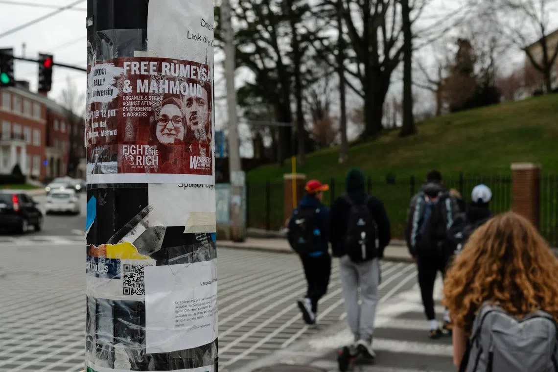 A flier calling for the release of Rumeysa Ozturk and Mahmoud Khalil is seen at a crosswalk at Tufts University.