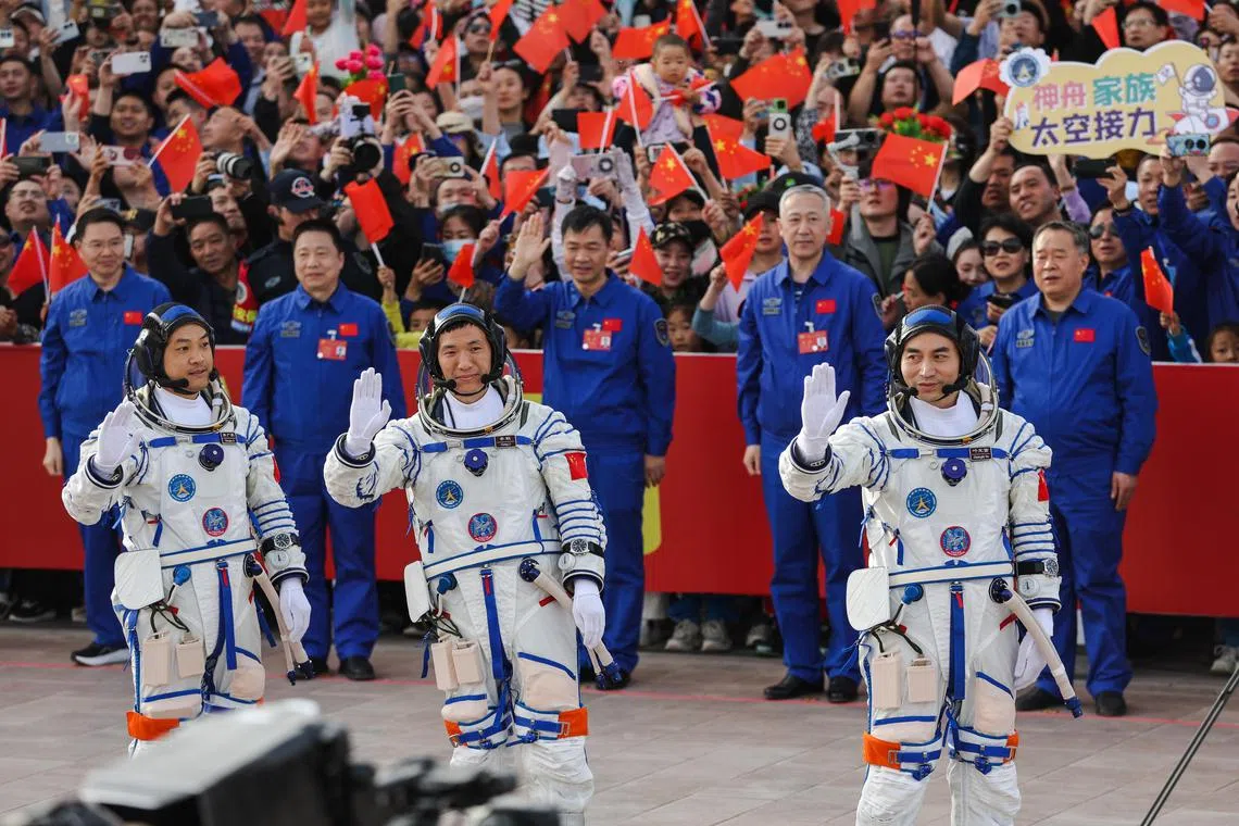 epa11299925 Shenzhou-18 manned spaceflight mission astronauts commander Ye Guangfu (R), Li Cong (C), and Li Guangsu wave during the see-off ceremony before the launch in Jiuquan, Gansu province, China, 25 April 2024. China's Shenzhou-18 manned spaceflight mission with three astronauts is the third manned spaceflight mission of China Space Station's development phase. The mission will last for about six months and the crew will carry out tasks such as installation, commissioning, maintenance, repair, and experiments in space.  EPA-EFE/WU HAO