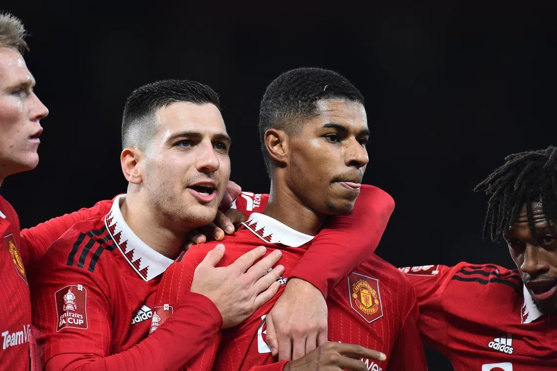 Manchester United's Marcus Rashford (centre, right), is congratulated by teammates after scoring against Everton.