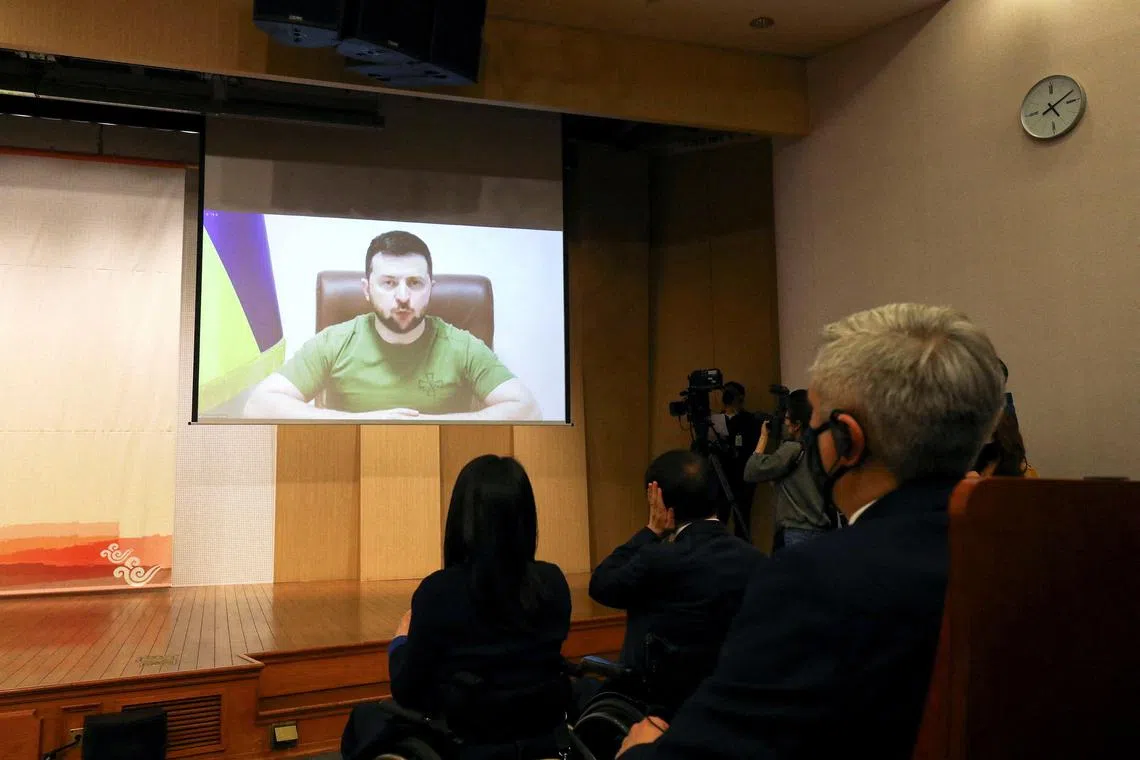 FILE PHOTO: Ukrainian President Volodymyr Zelenskiy addresses South Korean parliament via video link at National Assembly in Seoul, South Korea April 11, 2022. Chung Sung-Jun/Pool via REUTERS/File Photo