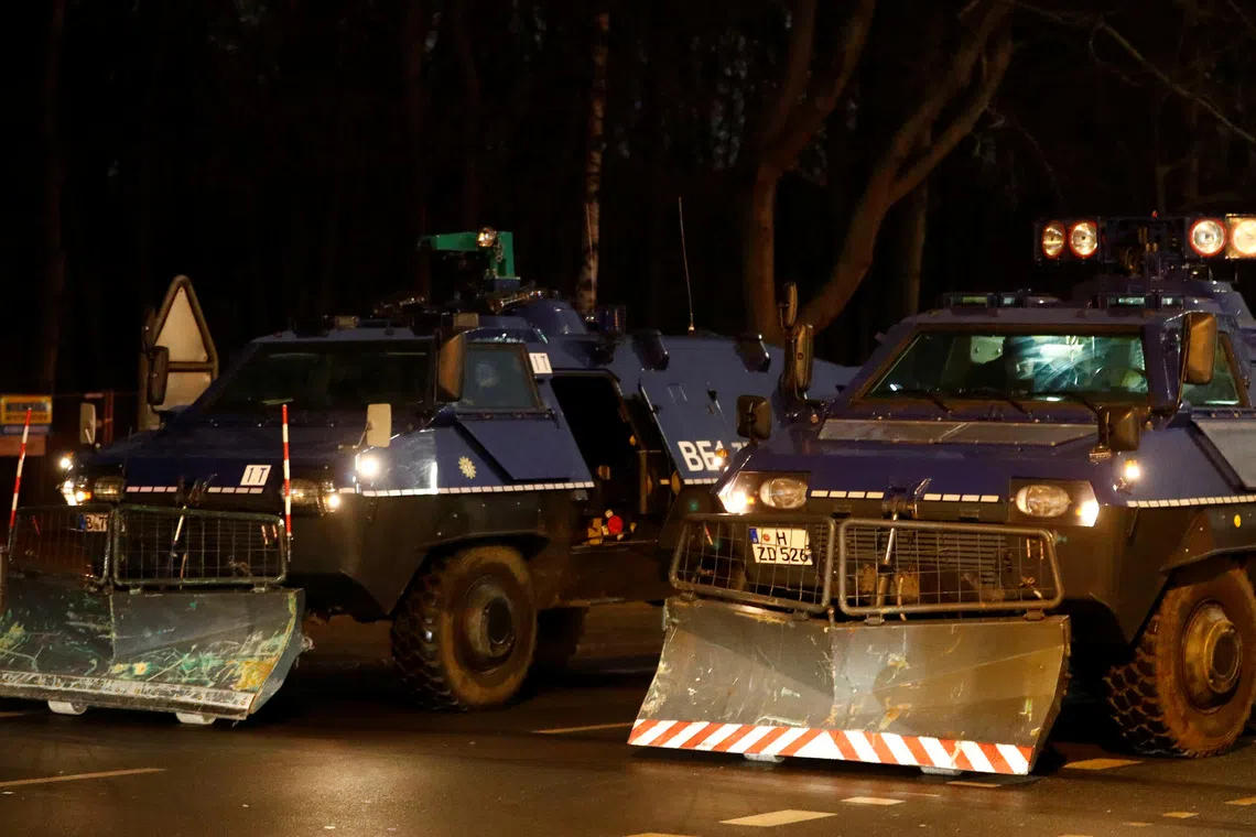 Armoured vehicles are seen near the Brandenburg Gate in Berlin, Germany, December 31, 2016. REUTERS/Fabrizio Bensch