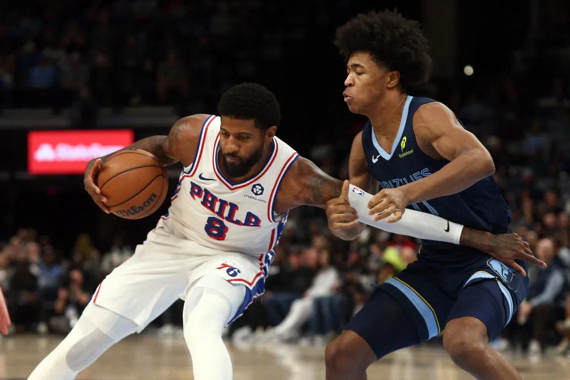 FILE PHOTO: Nov 20, 2024; Memphis, Tennessee, USA; Philadelphia 76ers forward Paul George (8) drives to the basket as Memphis Grizzlies forward Jaylen Wells (0) defends during the first half at FedExForum. Mandatory Credit: Petre Thomas-Imagn Images/File Photo