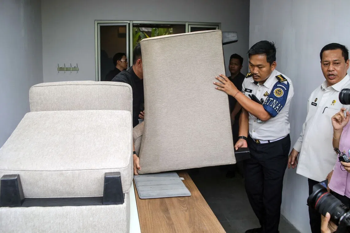 Officials carry away plush furniture from one of the “villas” in the Cibinong men’s prison, before the demolition of the structures in Bogor on Sept 30.