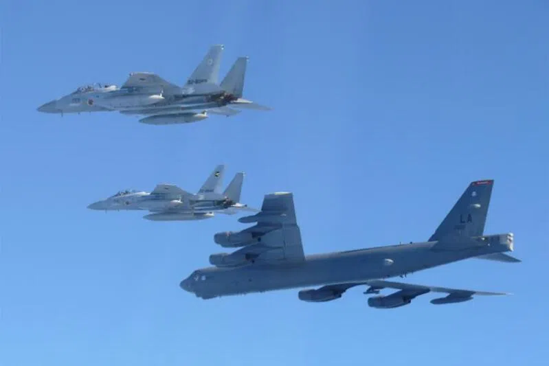 A US Air Force B-52 strategic bomber (bottom) and Japanese F-15 fighter jets during a joint exercise over the Sea of Japan on Dec 10, following joint patrols by Chinese and Russian aircraft.
