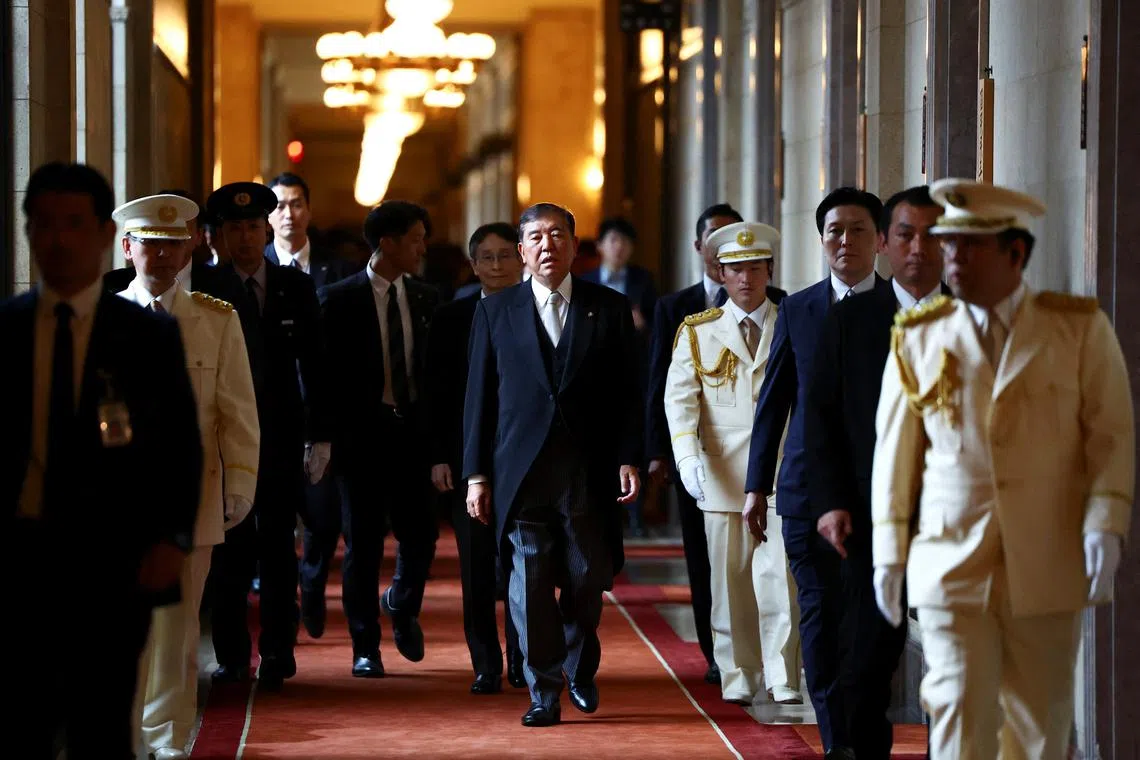 Japan's Prime Minister Shigeru Ishiba, wearing a formal attire, walks toward the upper house hall to attend an opening ceremony of the parliamentary session in Tokyo, Japan August 1, 2025. REUTERS/Issei Kato/File Photo
