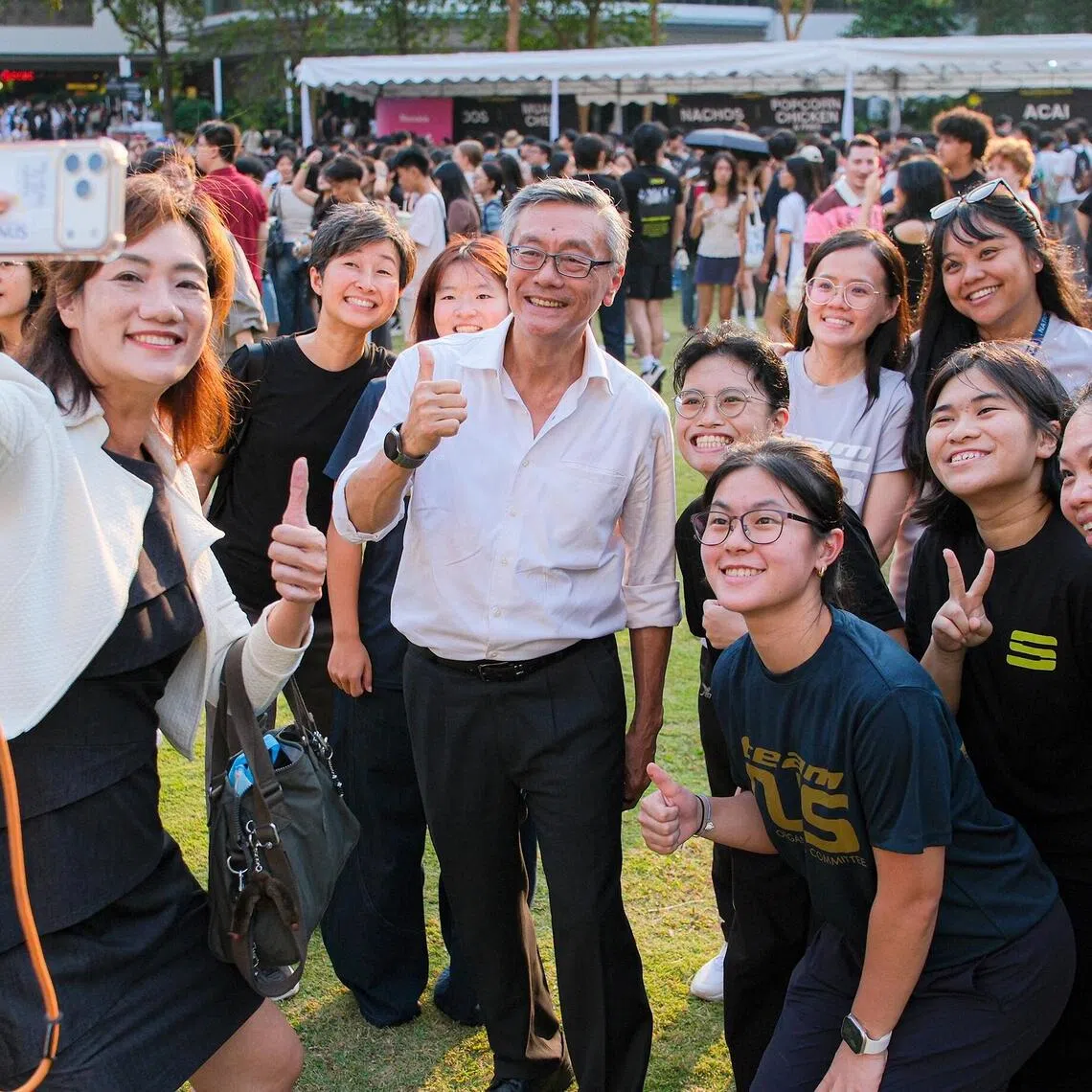 NUS president Tan Eng Chye with students and colleagues at Supernova 2026.