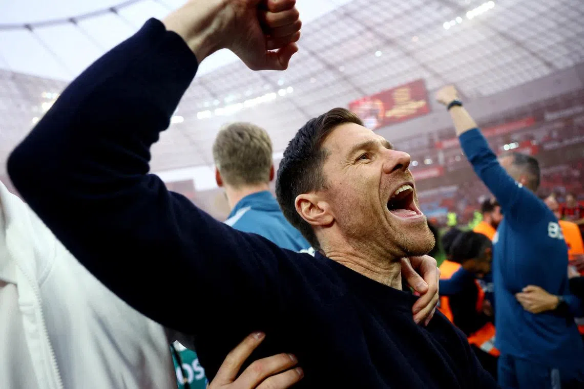 Soccer Football - Bundesliga - Bayer Leverkusen v Werder Bremen - BayArena, Leverkusen, Germany - April 14, 2024 Bayer Leverkusen coach Xabi Alonso celebrates after winning the Bundesliga REUTERS/Kai Pfaffenbach