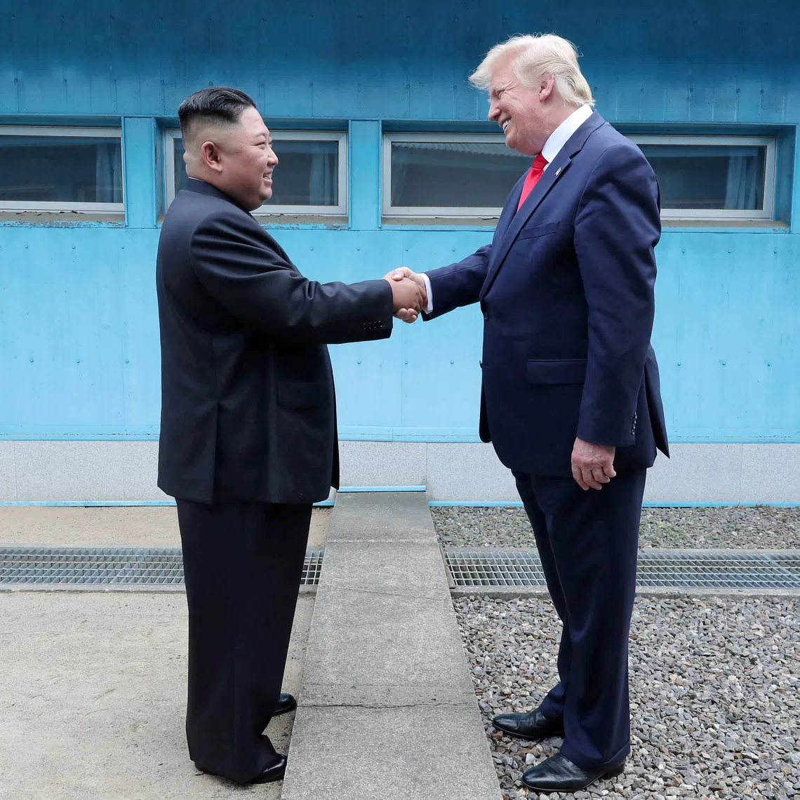 A 2019 photo shows US President Donald Trump (right) shaking hands with North Korean leader Kim Jong Un at the demilitarized zone in South Korea.