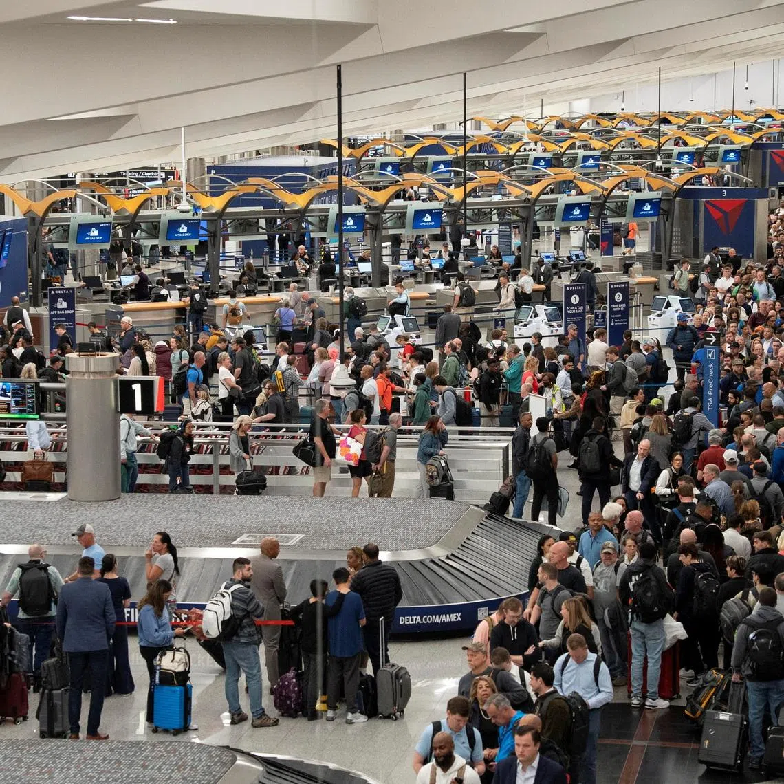 Passengers wait in line at Hartsfield-Jackson Atlanta International Airport on March 23.