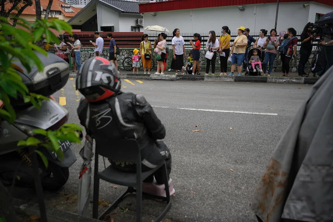 A group of people gathered along Ponggol Seventeeth Avenue at around 2.45pm, near the St. Francis Xavier Retreat Centre where the Pope will be staying, on Sept 11, 2024.