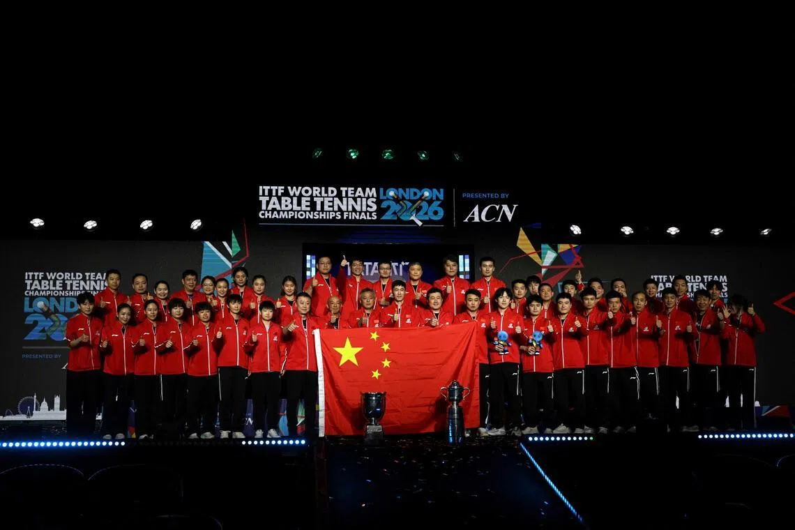 China's men's and women's teams pose for a photo after winning the team final matches at the ITTF World Table Tennis Championships in Wembley Arena, west London on May 10, 2026. 