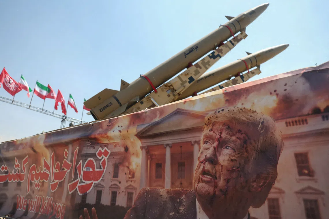 A banner with a picture of US President Donald Trump next to an Iranian missile system is seen at Azadi Square in Tehran.