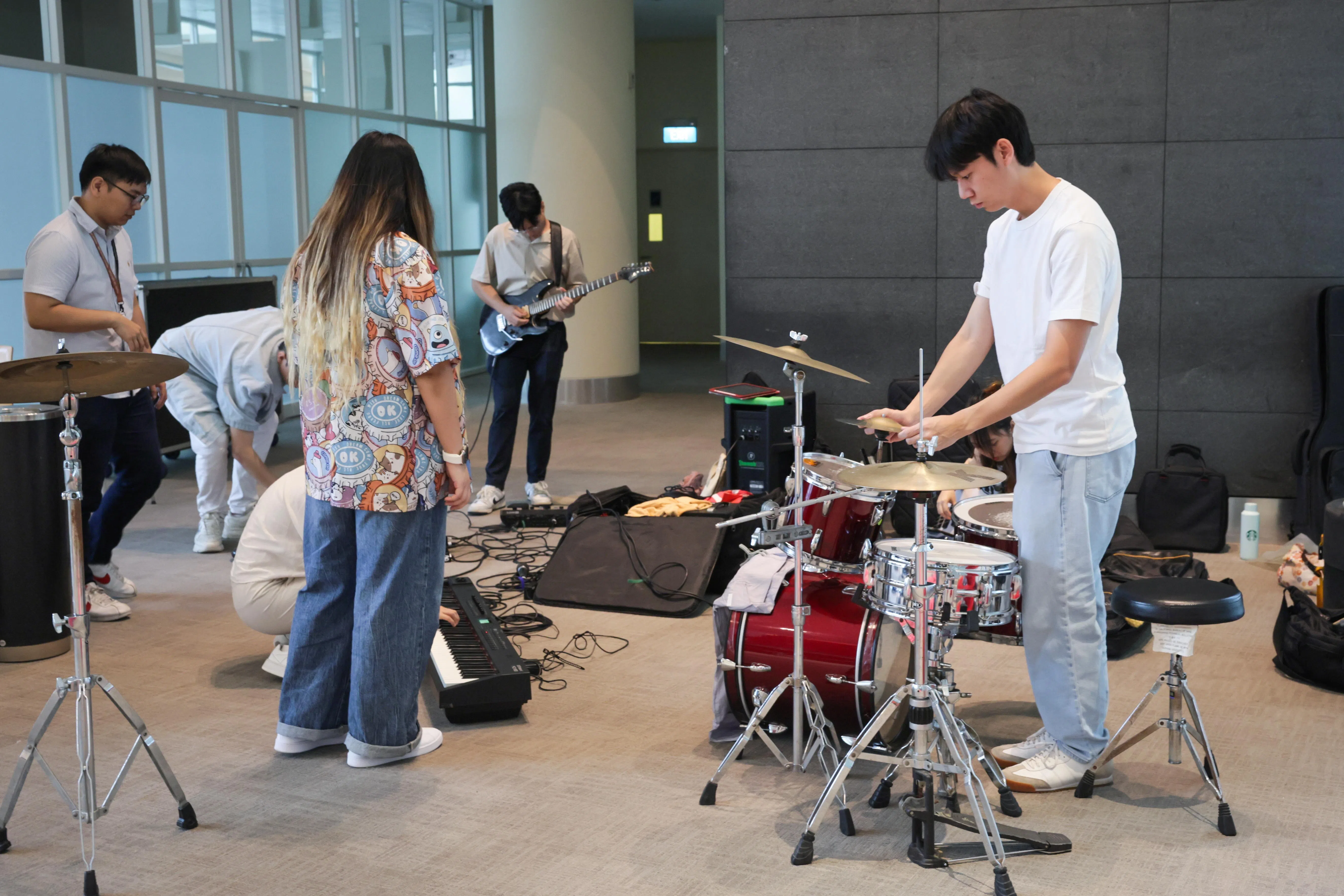 Buskers and busker-hopefuls preparing for a busking audition in July 2025.