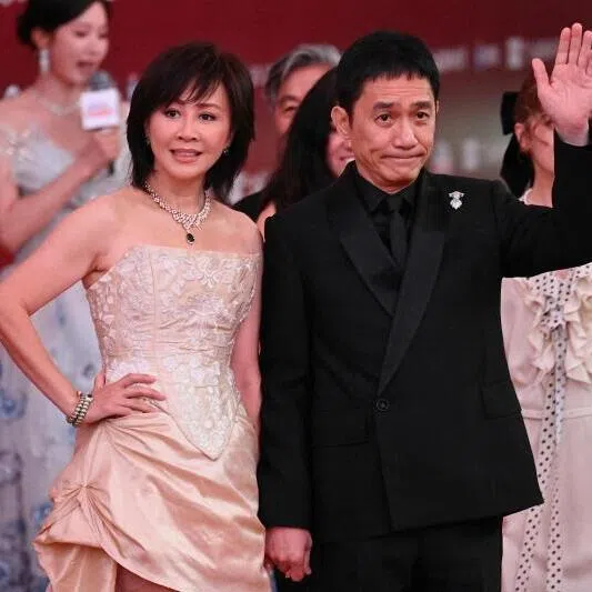 Hong Kong actress Carina Lau Ka Ling and Hong Kong actor Tony Leung Chiu Wai (right) arrive on the red carpet of the 28th Shanghai International Film Festival in Shanghai, on June 13.