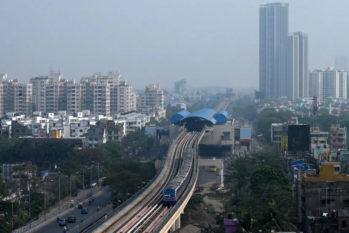 A metro train runs over a newly launched stretch between New Garia and Ruby stations, after commencement of its commercial services in Kolkata on March 15, 2024. (Photo by DIBYANGSHU SARKAR / AFP)