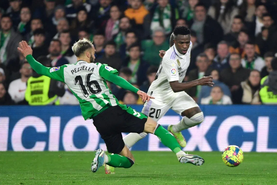 Real Betis defender German Pezzella vying with Real Madrid forward Vinicius Junior during the La Liga match at the Benito Villamarin stadium in Seville.