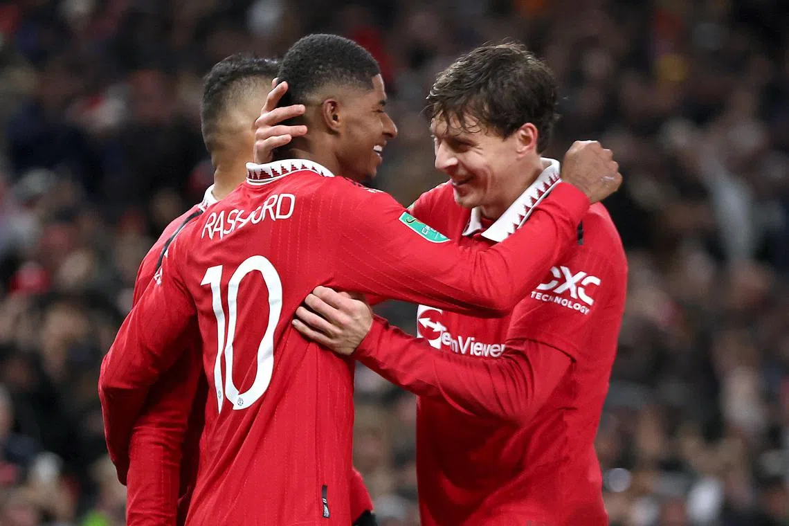 Manchester United's Marcus Rashford celebrates scoring their second goal with teammates.