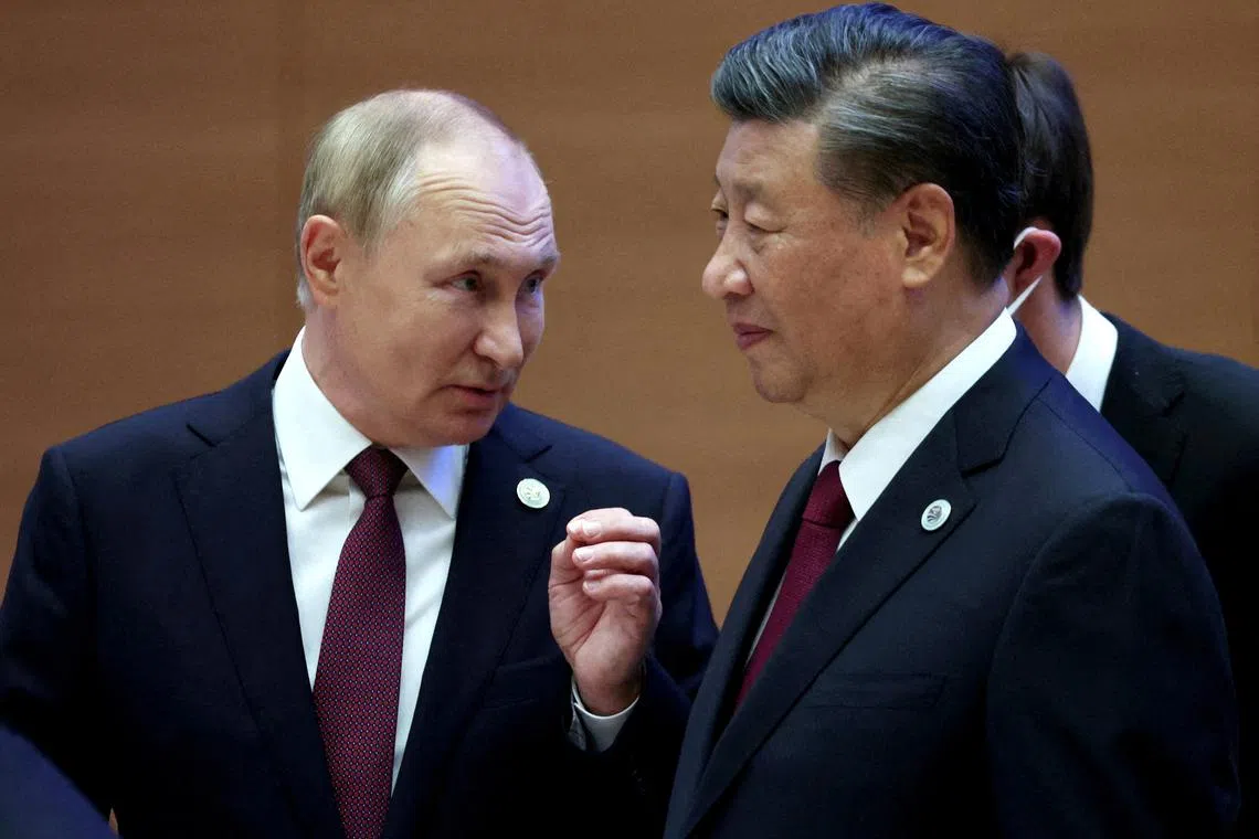 Russian President Vladimir Putin speaks with Chinese President Xi Jinping in Samarkand, Uzbekistan, on Sept 16, 2022.