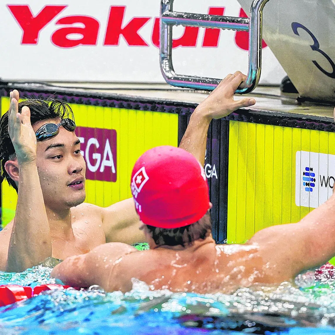 Noe Ponti of Switzerland congratulating Singapore's Teong Tzen Wei (left) for making the podium in the men's 50m butterfly final during the final day of World Aquatics Swimming World Cup Singapore leg at OCBC Aquatic Centre on Nov 2, 2024. ST PHOTO: KEVIN LIM dlswim02