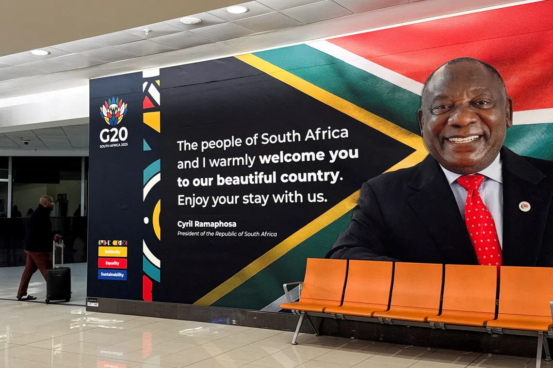 A person arrives at the O.R. Tambo International Airport, as South Africa prepares to host the G20 Summit from November 22 to 23, in Johannesburg, South Africa, November 20, 2025. REUTERS/Sodiq Adelakun