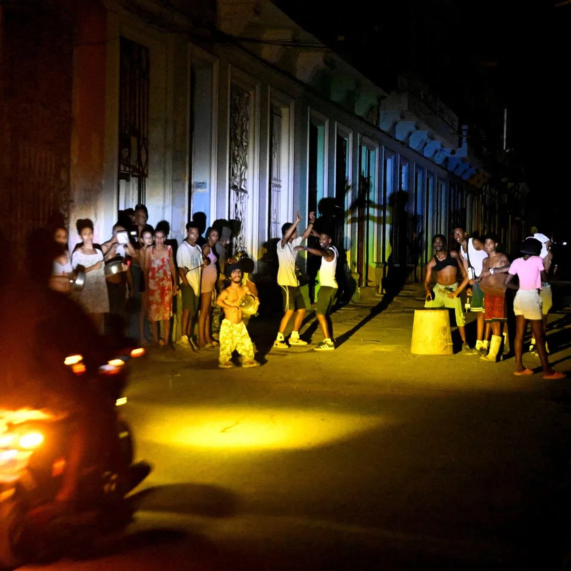 People gather on a street during a blackout as Cuba's national electric grid collapsed, according to the country's grid operator, leaving around 10 million people without power amid a U.S.-imposed oil blockade, in Havana, Cuba March 16, 2026.