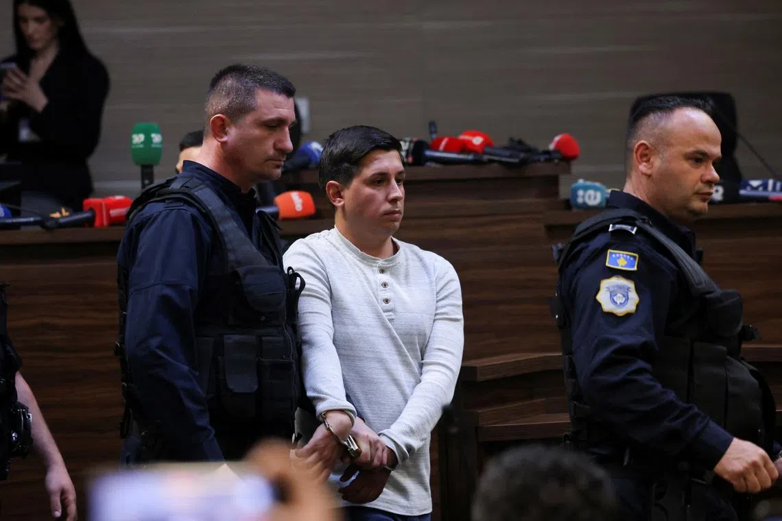 Kosovo police officers escort Dusan Maksimovic after he was sentenced to 30 years in prison, at the court in Pristina, Kosovo April 24, 2026. REUTERS/Valdrin Xhemaj