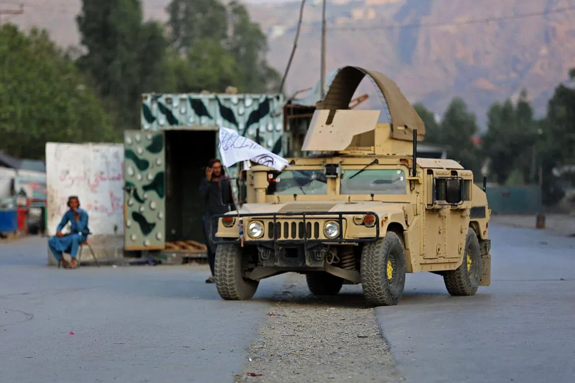A humvee (HMMWV) vehicle is seen near the closed gates of Torkham border crossing between Afghanistan and Pakistan in Afghanistan's eastern Nangarhar province on September 6, 2023. A gun battle erupted on September 6, between Pakistan and Afghan border forces, officials said, with each side blaming the other for starting the firefight that shut their busiest trade crossing. (Photo by Shafiullah KAKAR / AFP)