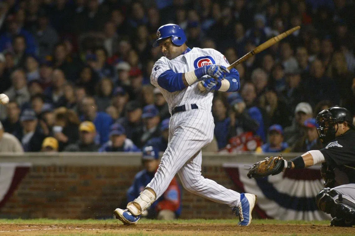 FILE PHOTO: Chicago Cubs' Sammy Sosa breaks his bat on an infield single to third base off Florida Marlins pitcher Carl Pavano during the sixth inning of play in Game 6 of their NLCS Championship series at Wrigley Field in Chicago, October 14, 2003. REUTERS/John Gress/File Photo
