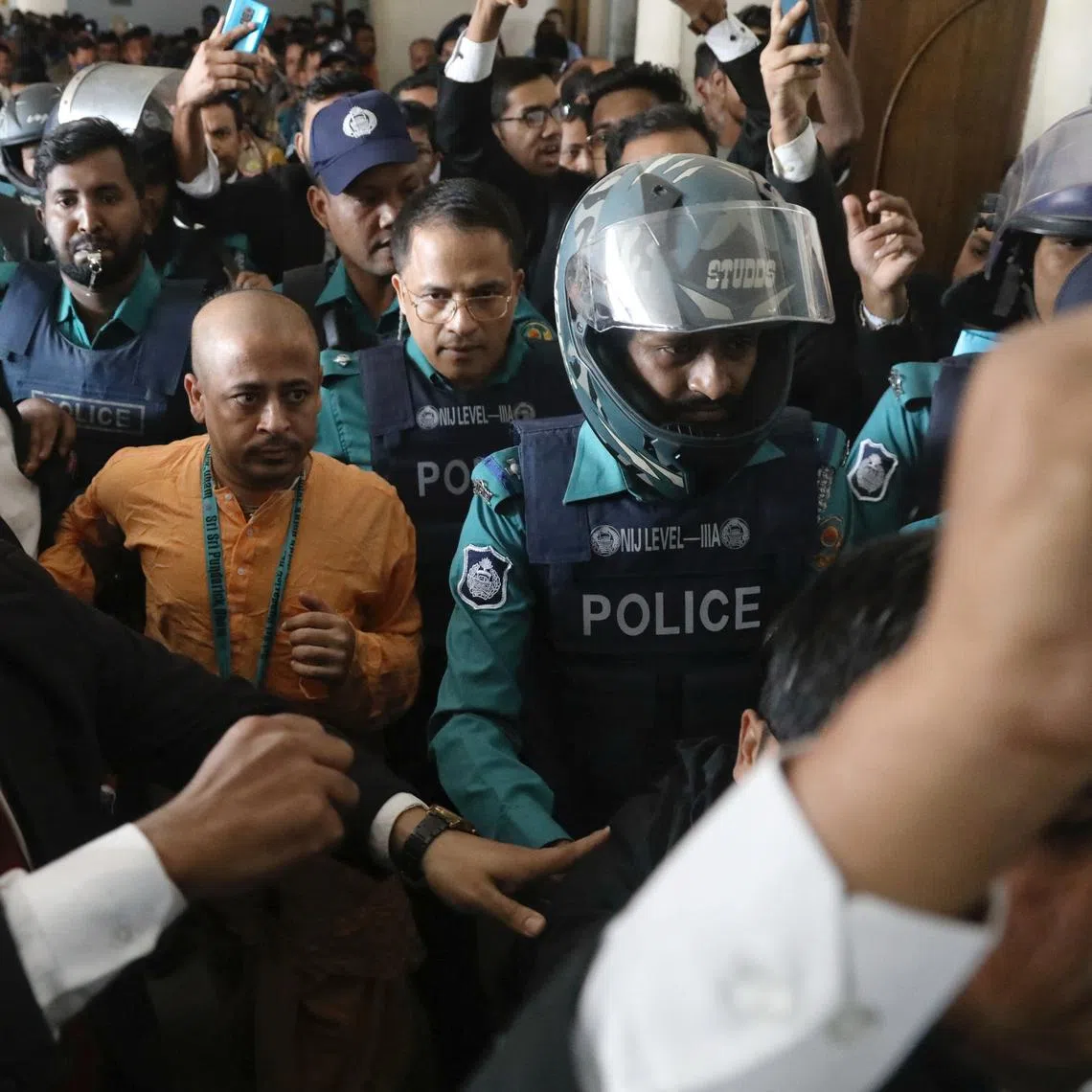 Chinmoy Krishna Das, a Hindu leader associated with the International Society for Krishna Consciousness (ISKCON), who faces several charges, is escorted by the police at the Chattogram Metropolitan Magistrate Court, in Chattogram, Bangladesh, November 26, 2024. REUTERS/Stringer