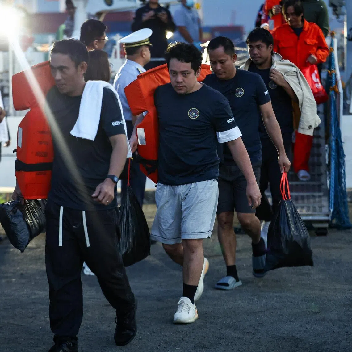 Crew members of the M/V Devon Bay who survived the sinking of the cargo ship disembark from a Philippine Coast Guard (PCG) vessel at the Port of Manila, Philippines, January 26, 2026. REUTERS/Eloisa Lopez