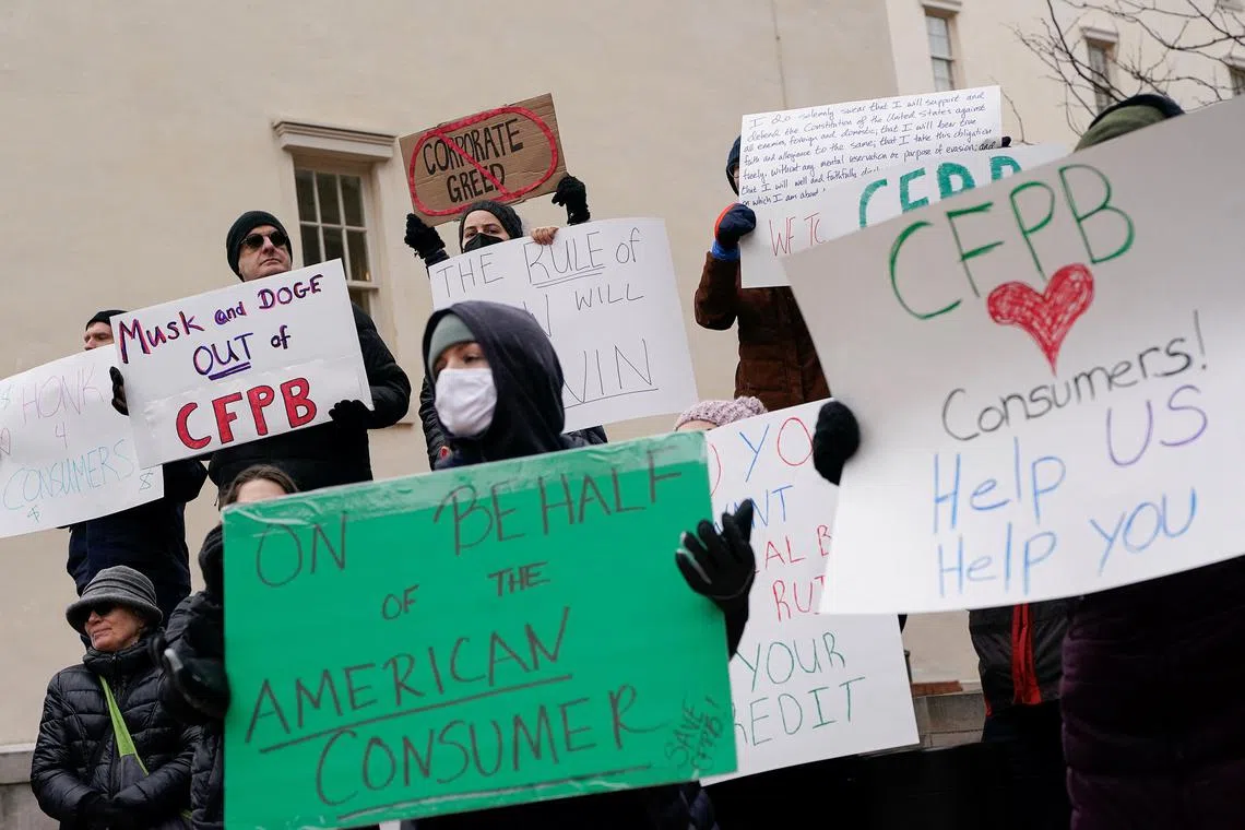 Demonstrators protest after Elon Musk's DOGE moved into CFPB headquarters, Washington, D.C., February 8, 2025. REUTERS/Nathan Howard/File Photo