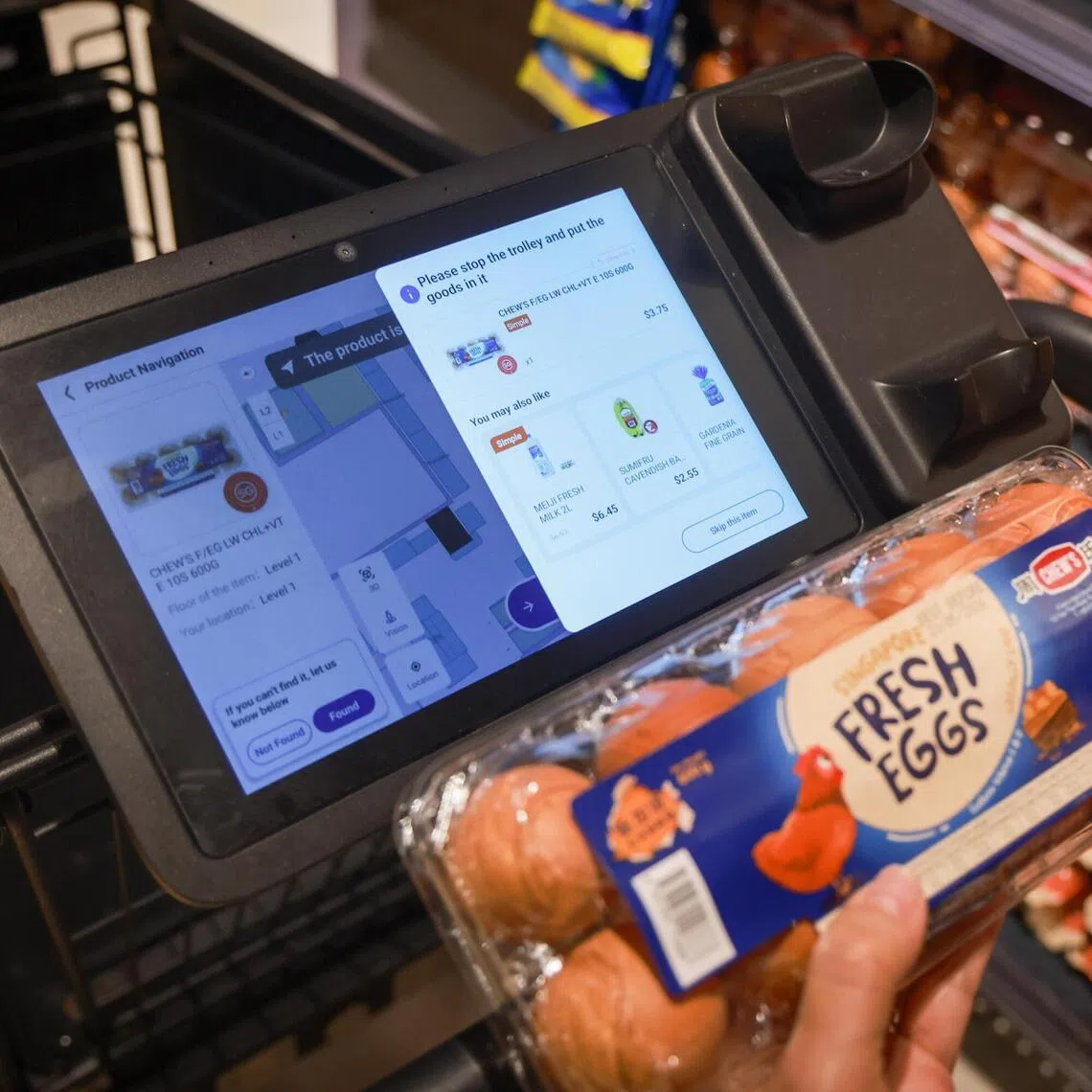 A customer scanning an item using a smart cart at Fairprice Finest at Punggol Coast on April 20.