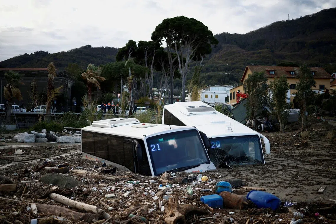 Damaged buses lie amongst debris following a landslide on the Italian holiday island of Ischia, Italy, Nov 27, 2022. 